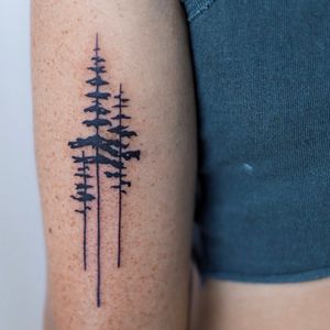 Unique blackwork design by Jenna Jeep, featuring a detailed tree motif on the upper arm.