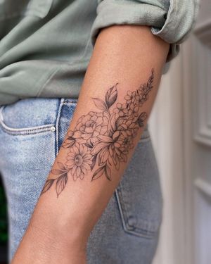 Bold blackwork design featuring a beautiful flower motif, perfect for the forearm. Trust talented artist Irene Bogachuk for stunning ink work!