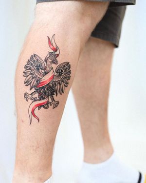 Capture the fierce beauty of an eagle in flight with this striking blackwork tattoo by Steven Brooks on the lower leg.
