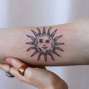 Capture the warmth of the sun with this bold blackwork forearm tattoo by Jenna Jeep. A timeless and illustrative design.