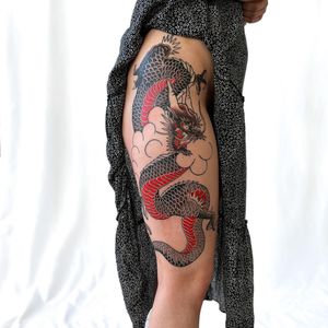 Experience the power and beauty of a Japanese dragon in this detailed illustrative tattoo on the upper leg by Leo Quintao.