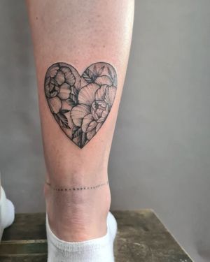 Illustrative design by artist Liza Vettaa, combining a flower and heart motif for a unique ankle tattoo.