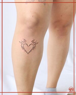 Express your love with a striking blackwork heart tattoo on your shin by the talented artist Tianna.