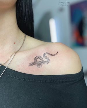 Get a stunning fine line snake tattoo on your shoulder by the talented artist Stasy Galz. Embrace the beauty of this sleek and intricate design.