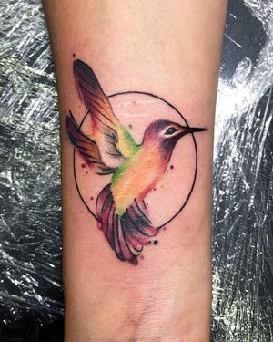 Illustrative forearm tattoo featuring a stunning hummingbird design by Juli Liverinova.