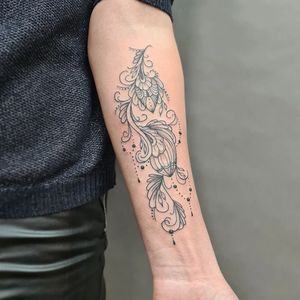 Beautiful blackwork forearm tattoo by Liza Vettaa, combining intricate flower and pattern elements in illustrative style.