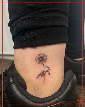 Get a beautifully detailed flower design on your ankle by tattoo artist Tianna. This fine line illustrative tattoo is sure to make a statement.