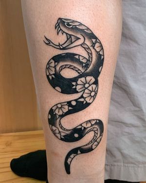 Get inked with a bold blackwork snake design on your forearm by Steven Brooks.