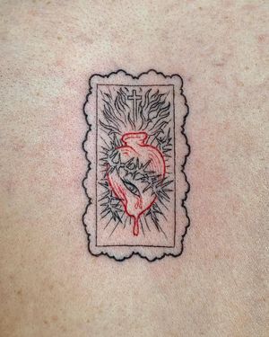 Fine line illustrative tattoo on chest by Holly Hawk featuring a heart, cross, and thorns motif.
