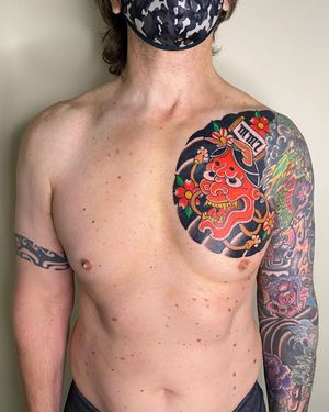 Experience the haunting beauty of a Japanese hannya mask tattooed on your chest in a illustrative style by the talented Leo Quintao.