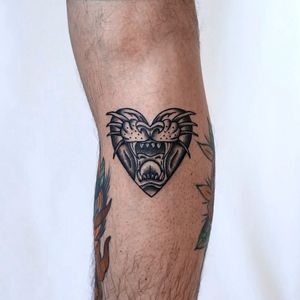 Get fierce with this blackwork tiger and heart tattoo by Jenna Jeep. A bold and illustrative piece for your arm.