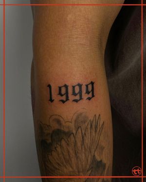 Celebrate the year 2022 with bold blackwork lettering and illustrative design by artist Tianna on your forearm.