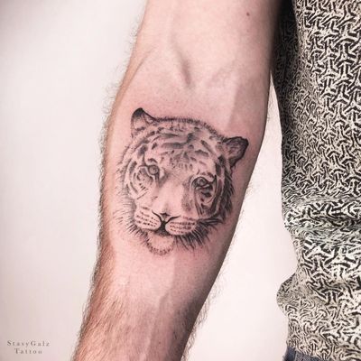 Immerse yourself in the wild with this stunning tiger forearm tattoo by Stasy Galz. The intricate blackwork design brings this majestic creature to life in a realistic and illustrative style.