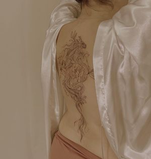 Get a stunning blackwork dragon and flower illustration on your back by the talented artist Palena.
