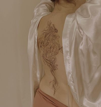 Get a stunning blackwork dragon and flower illustration on your back by the talented artist Palena.