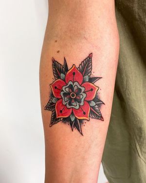 Get a beautiful traditional flower tattoo on your forearm by artist Steven Brooks.