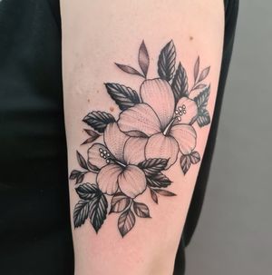 Blackwork upper arm tattoo featuring a beautiful illustrative flower design by the talented artist Liza Vettaa.