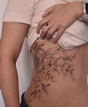 Unique blackwork design by Irene Bogachuk, featuring a detailed chrysanthemum flower on the ribs.