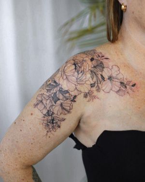 Beautiful blackwork flower tattoo on shoulder by Sasha Sunshine. Detailed and unique design.