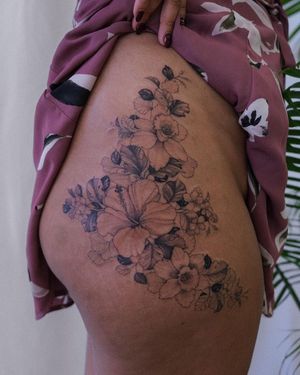 A stunning blackwork and illustrative design of a flower on the upper leg, expertly done by the talented artist Sasha Sunshine.