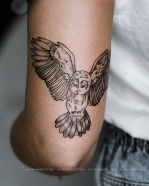 A striking blackwork tattoo of an owl by artist Kateryna Tytarenko, beautifully rendered on the upper arm.