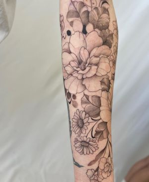 An illustrative blackwork tattoo of a beautiful flower, designed by Yasmin Clara, perfect for the forearm.
