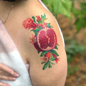 Beautiful illustrative design by Daniel Verdysh featuring a vibrant pomegranate and flower motif on the shoulder.