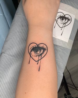 Blackwork illustrative tattoo featuring a heart, eye, and tears, done by artist Steven Brooks.