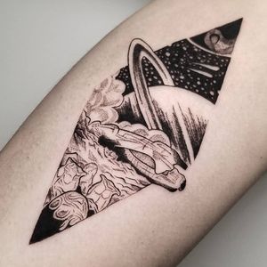 Explore the cosmos with this blackwork alien planet tattoo on your arm. By the skilled artist Inkcognito.