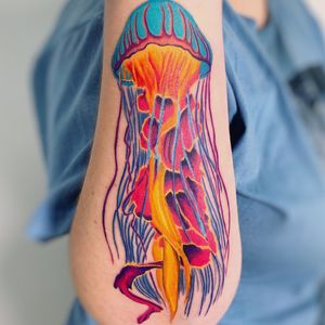 Get mesmerized by the illustrative beauty of this jellyfish tattoo by Daniel Verdysh. Vibrant colors bring the underwater creature to life on your forearm.