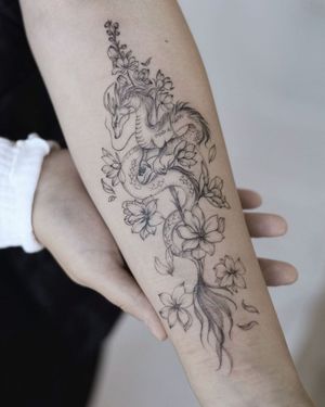 Impressive forearm piece combining a fierce dragon and delicate flower in Palena's illustrative style.