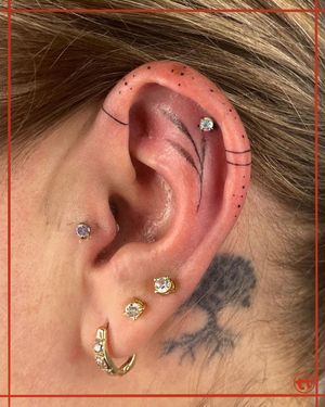 Enjoy intricate dotwork & fine line detailing in this illustrative leaf pattern tattoo on the ear. Created by the talented artist, Tianna.