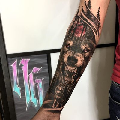 Get lost in the mesmerizing blend of blackwork, realism, and illustrative styles by Nicole Histon, featuring a captivating moon, wolf, and tree motif on your forearm.