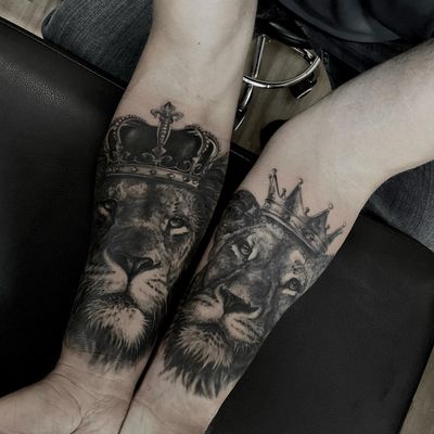 A striking blackwork forearm tattoo featuring a majestic lioness wearing a crown, symbolizing strength and royalty. By talented artist Nicole Histon.