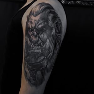 Impressive blackwork orc illustration by Nicole Histon, bringing a powerful presence to your upper arm.