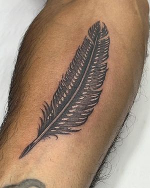 Elegant black and gray feather tattoo on upper leg by talented artist Sophie Rose Hunter.