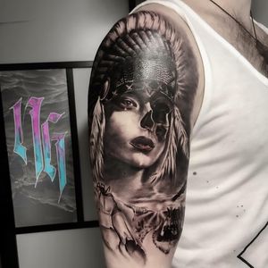 Stunning blackwork realism tattoo by Nicole Histon featuring a skull, feather, and woman. A perfect blend of edgy and elegant.