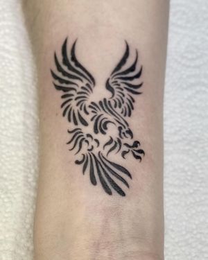 Stunning arm tattoo by Sophie Rose Hunter featuring an ignorant style phoenix motif. Bold and symbolic design.