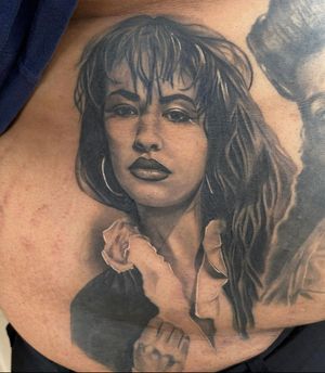 Stunning black and gray illustration of a woman on the ribs by Lokey, expert in realism tattoos.