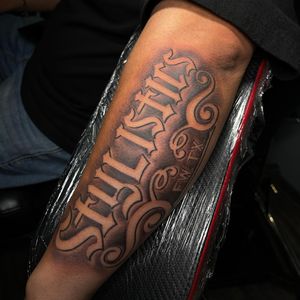 Get a bold and artistic name tattoo on your forearm by the talented artist Lokey. Stand out with custom lettering and illustrations.