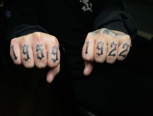 Get a unique and meaningful finger tattoo with the year of your choice, expertly done in minimalist lettering by artist Lokey.