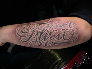 Let Lokey's name shine on your forearm with this expertly crafted lettering and illustrative style tattoo.