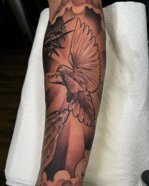 Illustrative bird tattoo on forearm by Lokey, featuring bold blackwork design.