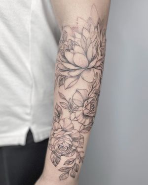 Beautiful blackwork peony tattoo by Mengni Yang, showcasing intricate floral design on forearm.