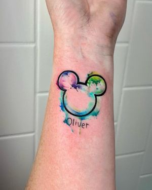 Vibrant watercolor lettering and illustrative Mickey design by Mengni Yang on forearm.
