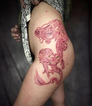 Explore the intricate fusion of traditional Japanese style with an illustrative twist in this mesmerizing tattoo by Mengni Yang, featuring a powerful dragon and delicate flower on the upper leg.