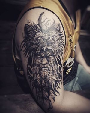 Unique blackwork tattoo by Tom Cobra illustrating a man connecting with a wolf under the moon. Express your wild side.