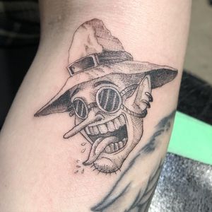 Detailed arm tattoo featuring hat, goggles, and piercing on a man, done by Pablo in an illustrative style.