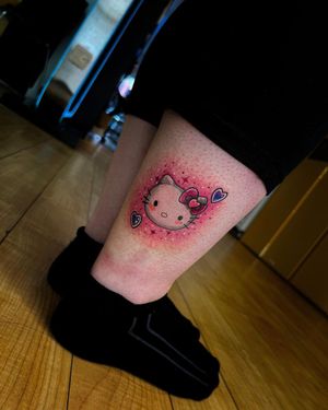 Adorn your lower leg with a cute and playful design featuring a heart and Hello Kitty, by tattoo artist Alina Ivenko.