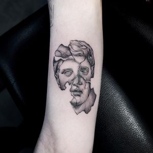 Discover the power of blackwork illustration with this stunning forearm tattoo of a man resembling a statue, created by the talented artist Oek.